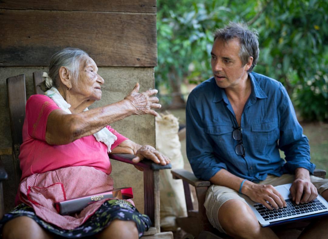 Dan Buettner speaking to woman in Blue Zone